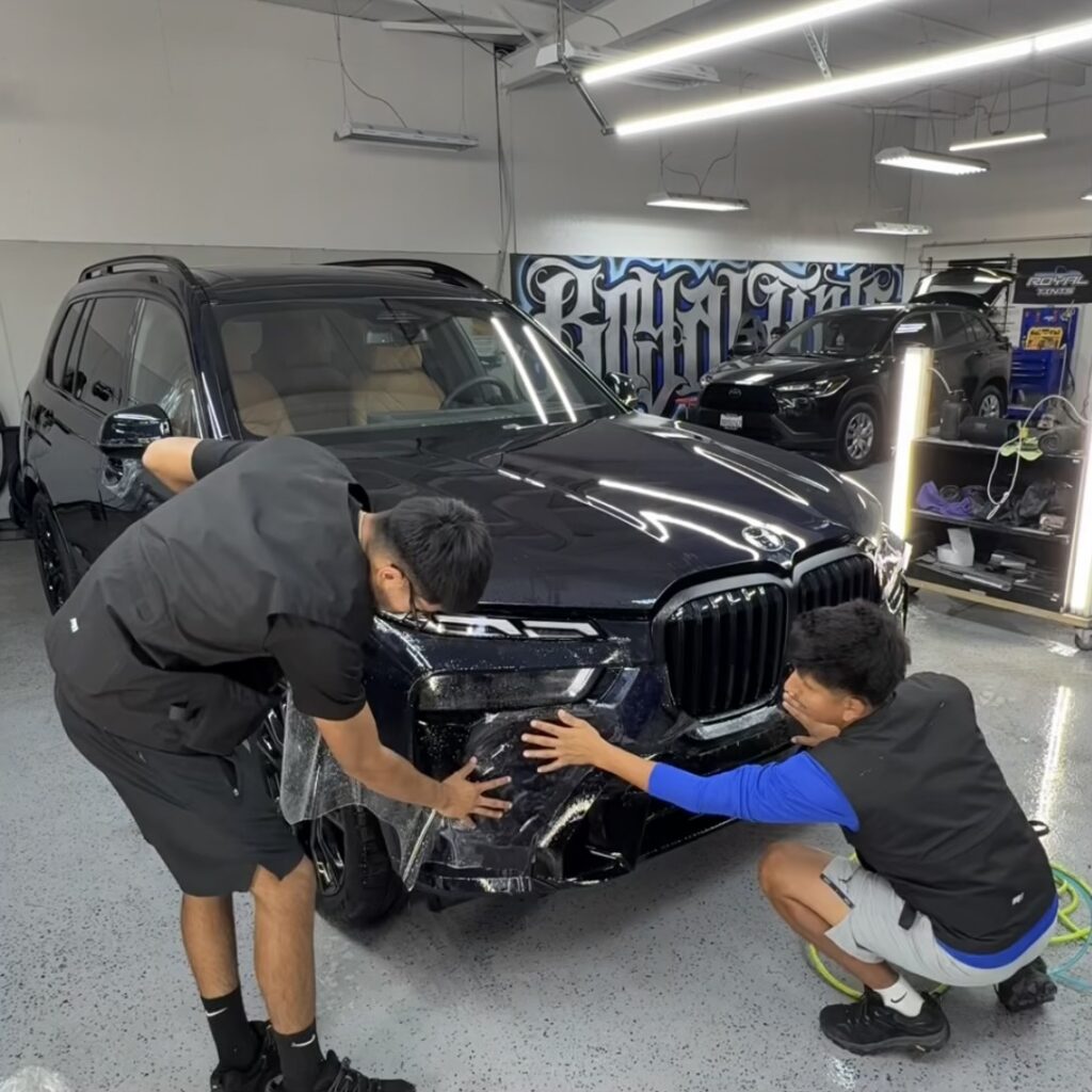 PPF ten year self healing paint protection film being installed on Black BMW SUV in Santa Rosa