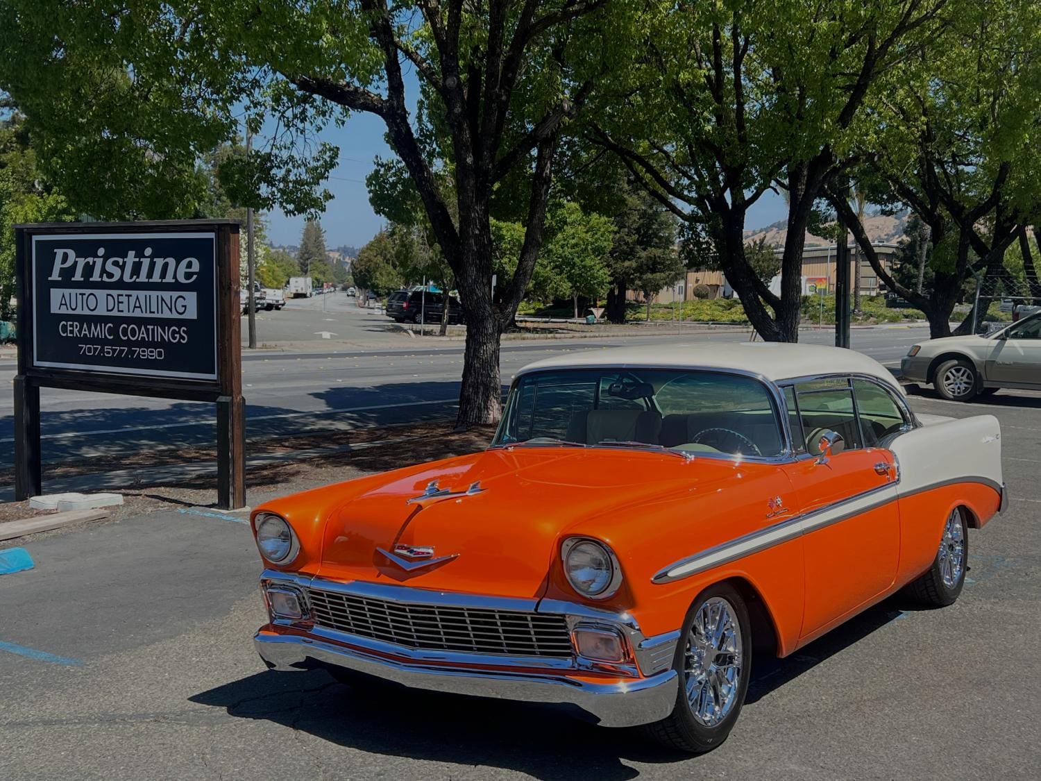 Orange and white classic car in parking lot