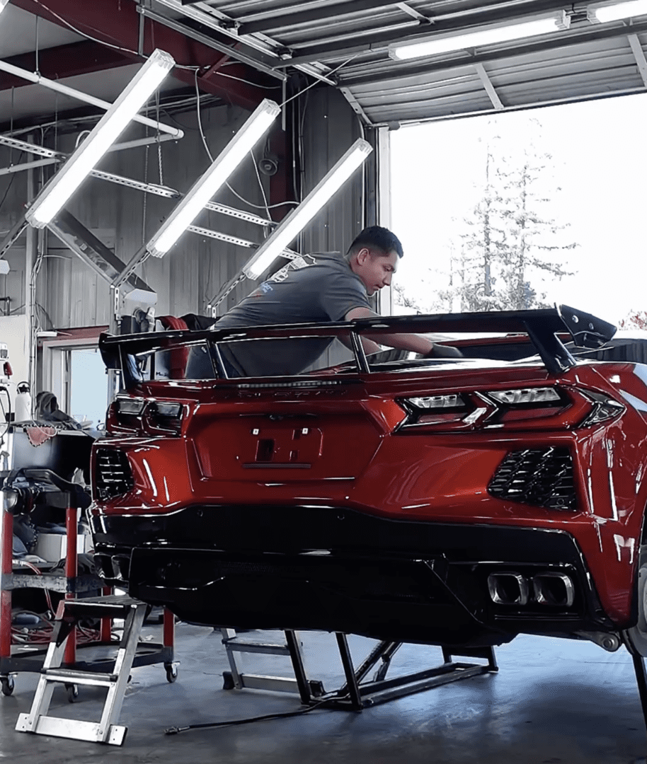 Ceramic coating being applied to red C8 Corvette